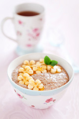 Oatmeal porridge with banana and flax seed, selective focus