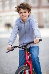 Fototapeta na wymiar Urban biking - teenage boy and bike in city