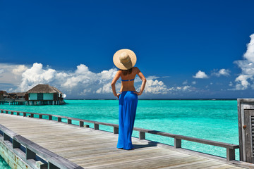 Woman on a beach jetty at Maldives