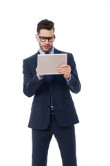 Focused businessman using a digital tablet.