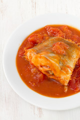 fish in sauce in white plate