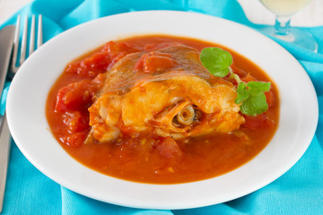 fish with tomato sauce in plate
