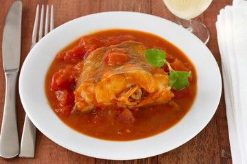 fish with tomato sauce in white bowl