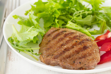 grilled meat with salad on the plate