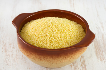 couscous in brown bowl in white table