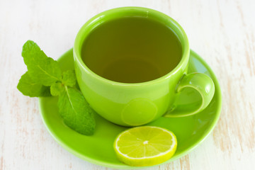 green cup with tea