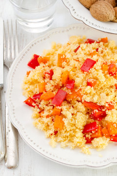 couscous on the plate with glass of wine