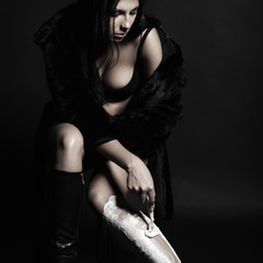 Beautiful brunette girl shaves her legs