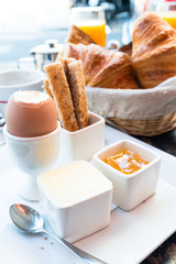 Breakfast with orange juice and fresh fruit jam on table