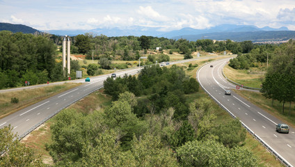 Highway with cloudy sky and mountain landscape in France