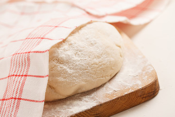 Dough on wooden board