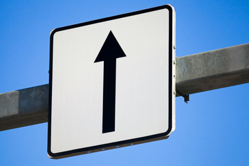 Go straight traffic sign with black arrow