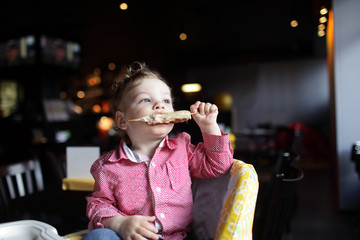 Child biting kebab