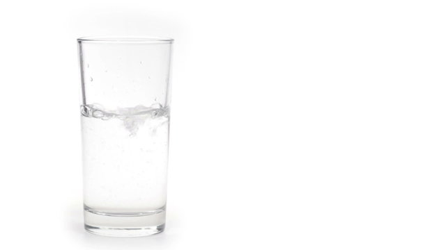 Glass of water with ice isolated on white background.