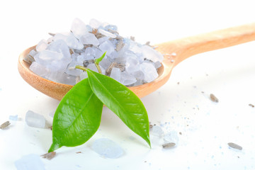 Sea salt poured from wooden spoon