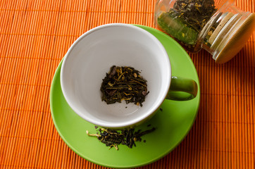 afternoon green tea cup with on orange mat