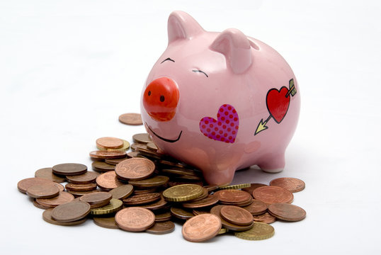 pink piggy money box on coins