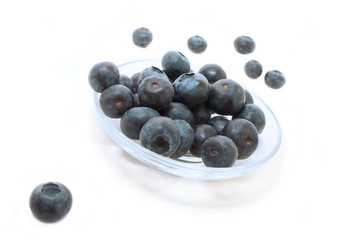 ripe big  blueberries in the plate on a white background
