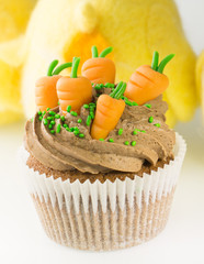 Easter cupcake with carrots decoration and chocolate cream