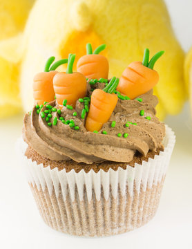 Easter cupcake with carrots decoration and chocolate cream