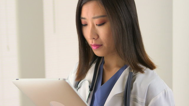 Chinese woman doctor using tablet