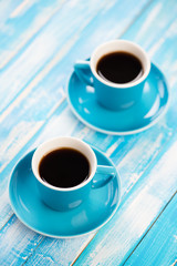 Two cups with black coffee, studio shot, view from above