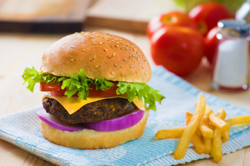 cheese burger , french fries and fast food with plenty of raw ma