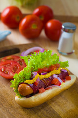 hot dog fast food with plenty of raw ingredients on the backgrou