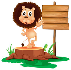 A lion above a trunk beside a wooden signboard