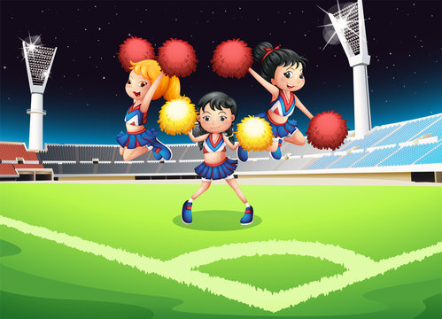 Three cheerdancers performing in the soccer field