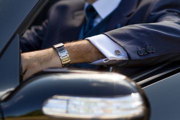 Groom wearing luxury watches and suit on a wedding day