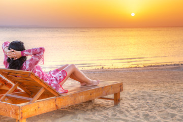 Beautiful woman relaxing at sunrise over Red Sea in Egypt