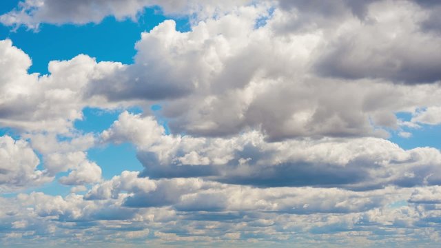 Time lapse clip of fluffy clouds over blue sky