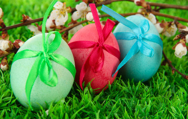 Colorful eastern eggs on  grass close-up
