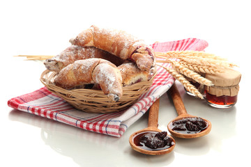 Taste croissants in basket and jam isolated on white.