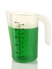 Measuring cup with green liquid isolated on white