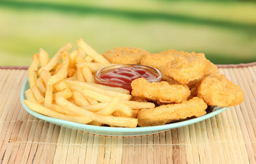 Fried chicken nuggets with french fries and sauce