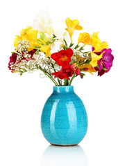 Beautiful bouquet of freesia in blue vase isolated on white