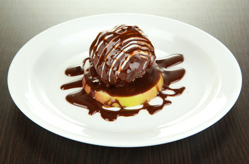 Chocolate dessert on big plate on wooden table