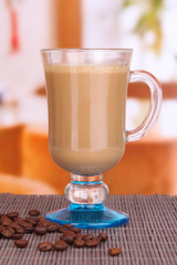 Layered coffee in glass on table on bright background