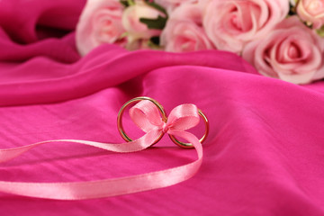 Wedding rings tied with ribbon