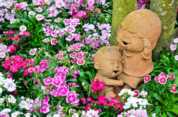 Smiling clay dolls in the garden