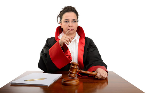 Angry female judge striking the gavel to keep silence