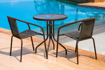 Table and chairs next to the pool