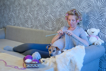Pregnant woman knitting for baby
