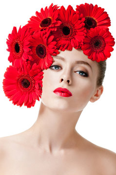 fashion model with hairstyle and red flowers in her hair.
