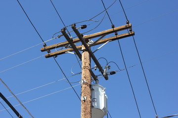 Telegraph poles against a blue sky