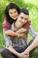 Naklejka premium Couple Relaxing on Green grass