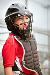 Portrait of child playing catcher in baseball game