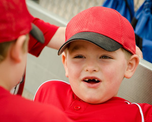 Portrait of child in dugout before baseball game